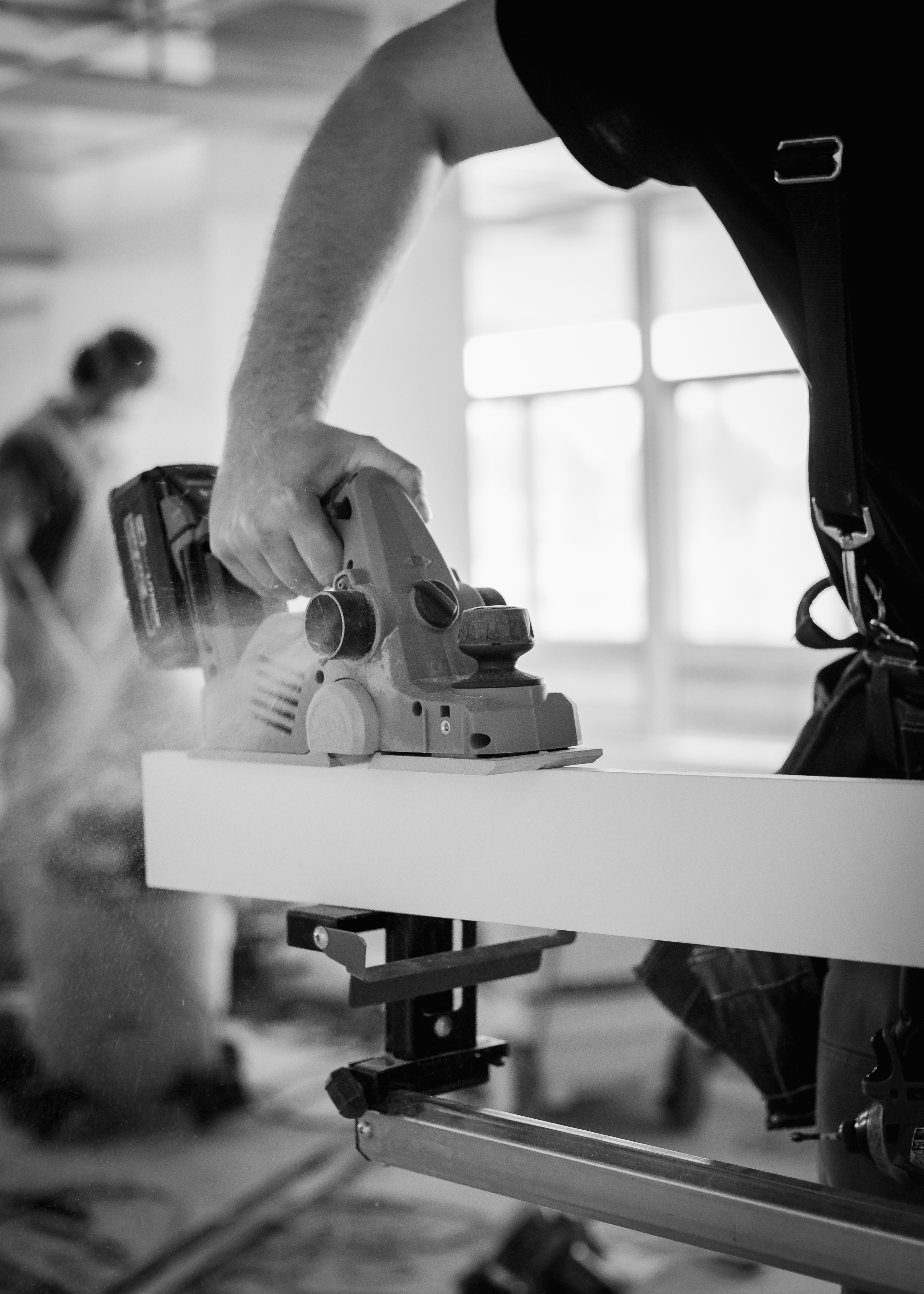 Tradesperson cutting material with a power tool during construction