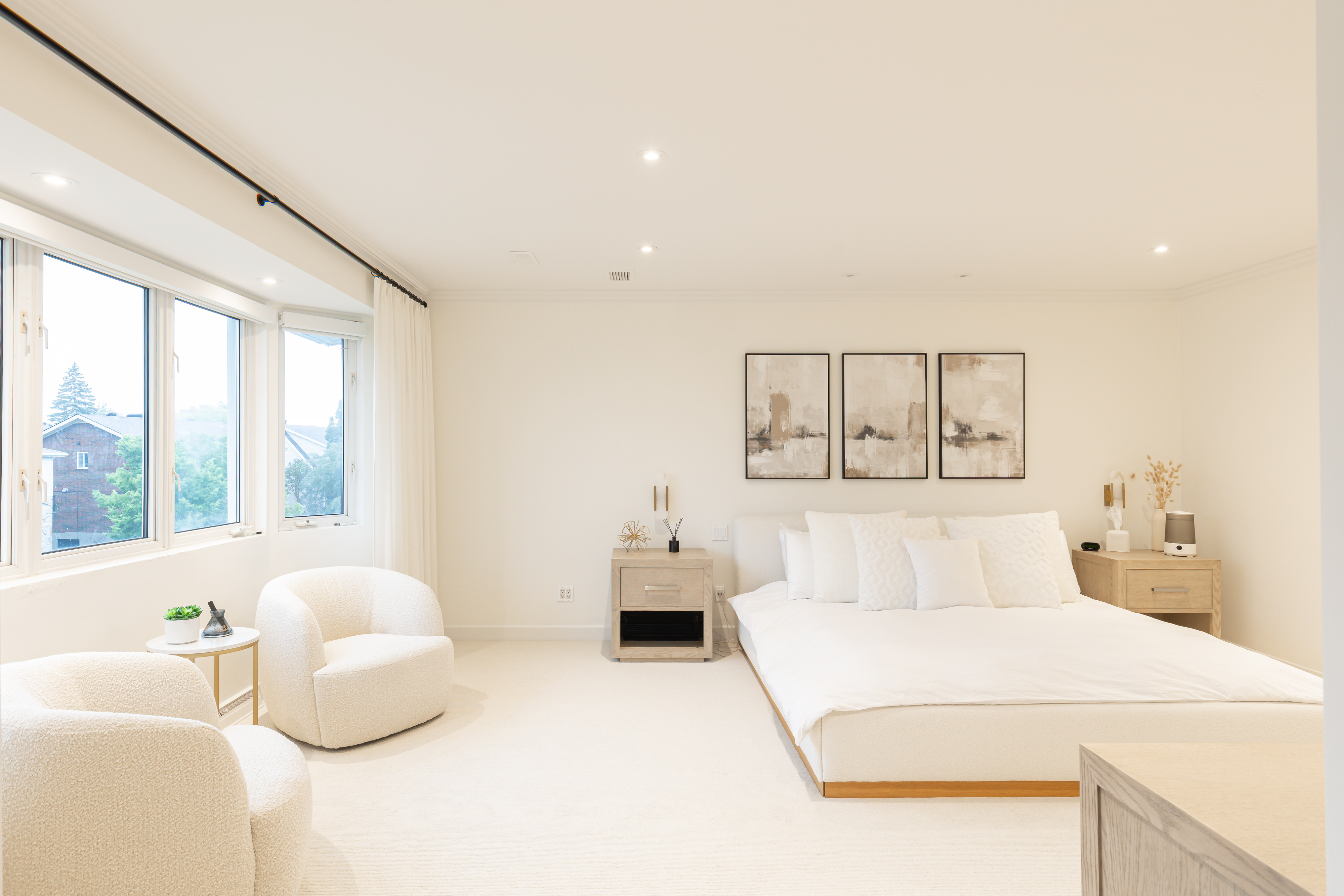 Bright luxury residence interior with a bedroom and sitting area